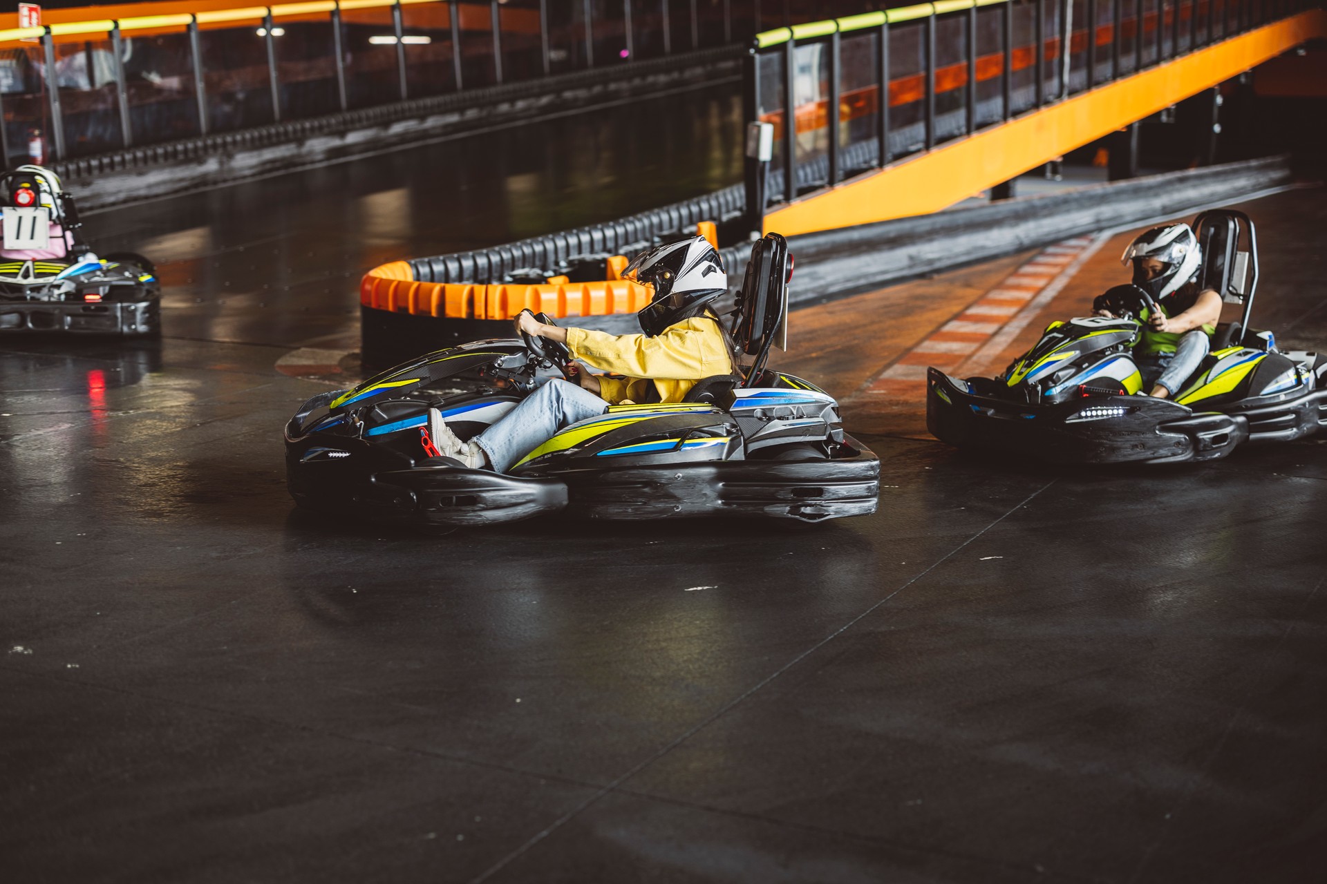 Go-Kart Racers group of young friends curve on circuit